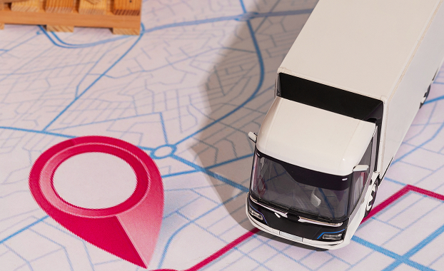 A commercial truck and financial charts, representing the cost of commercial auto insurance.